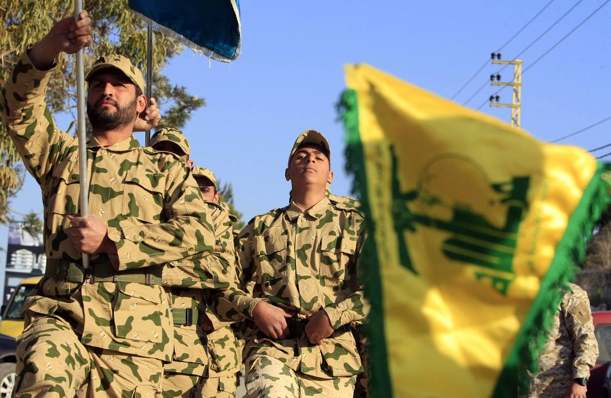 Hezbollah fighters parade during a ceremony to honor fallen comrades, in Tefahta village, south Lebanon, Feb. 18, 2017.
